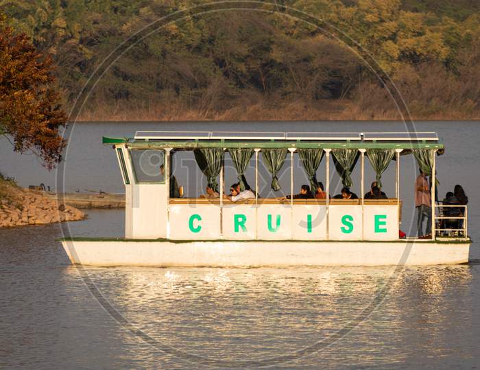 people sittinf in Small cruise ship in sukhna lake chandigarh