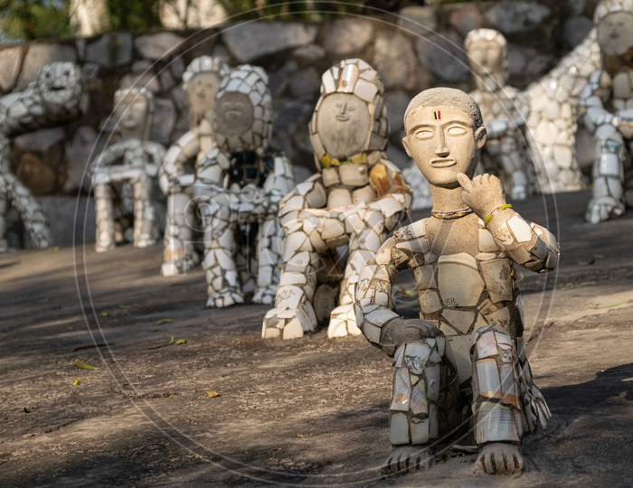 sculptures of men decorated with broken tiles at rock garden chandigarh