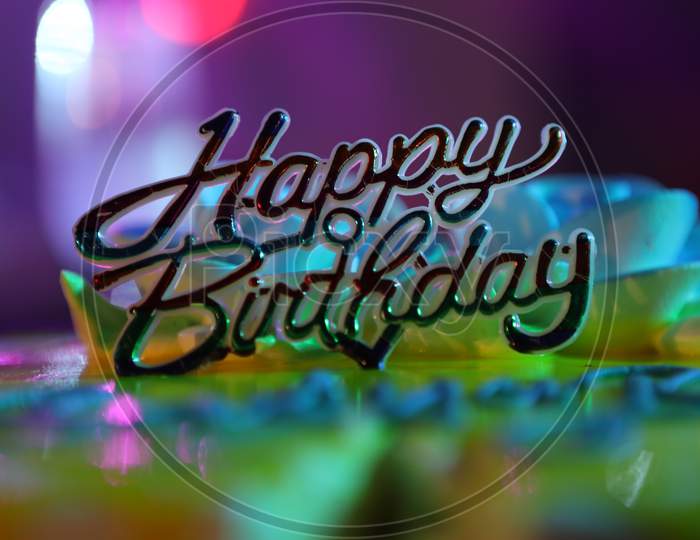 Happy Birthday Tag On an Birthday Cake With Neon Lights Background