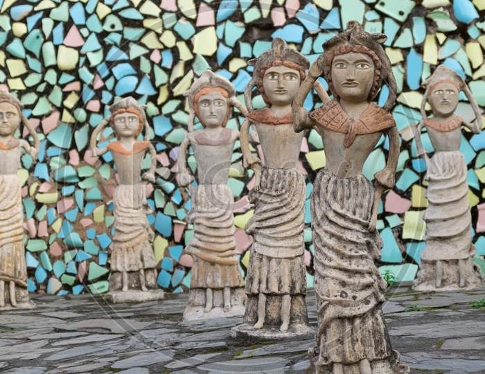 sculptures and decorated wall with broken tiles at rock garden chandigarh