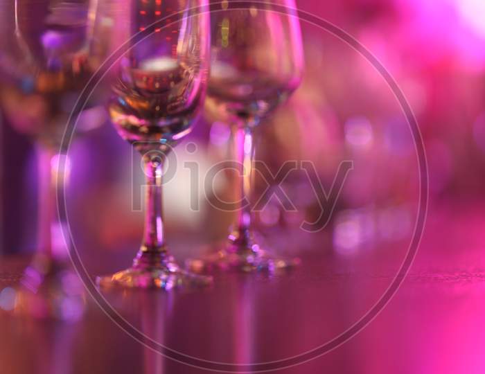 Wine Glasses In an Pub With Neon Lights Flare