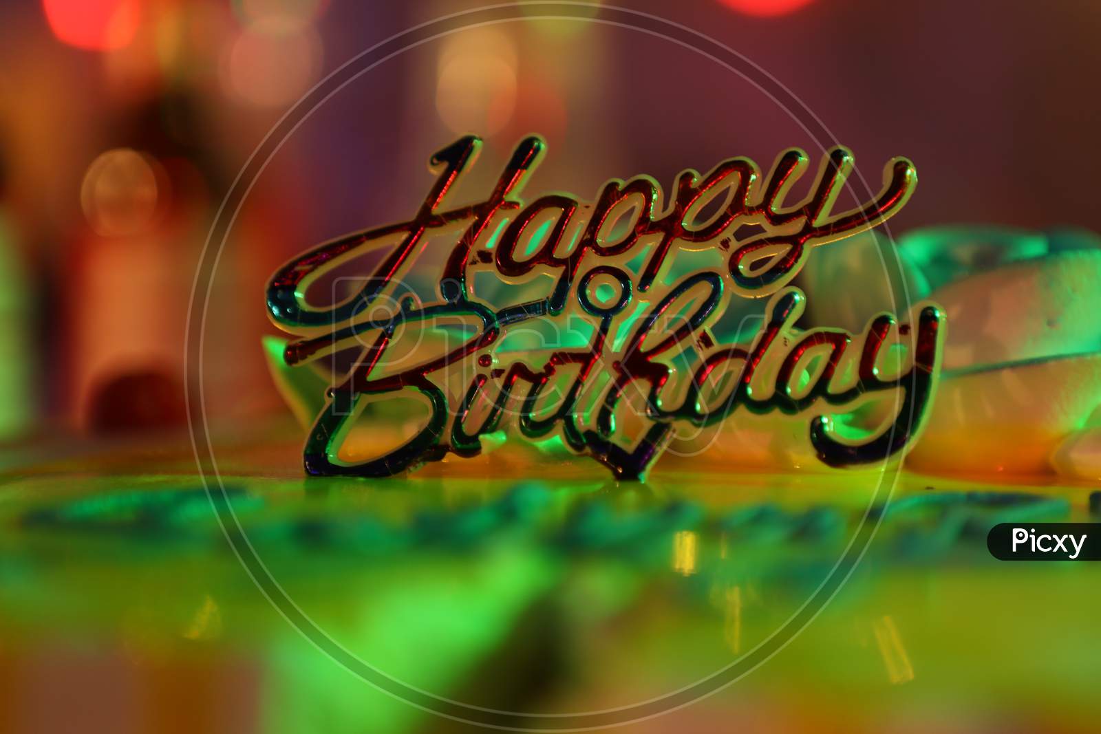 Happy Birthday Tag On an Birthday Cake With Neon Lights Background