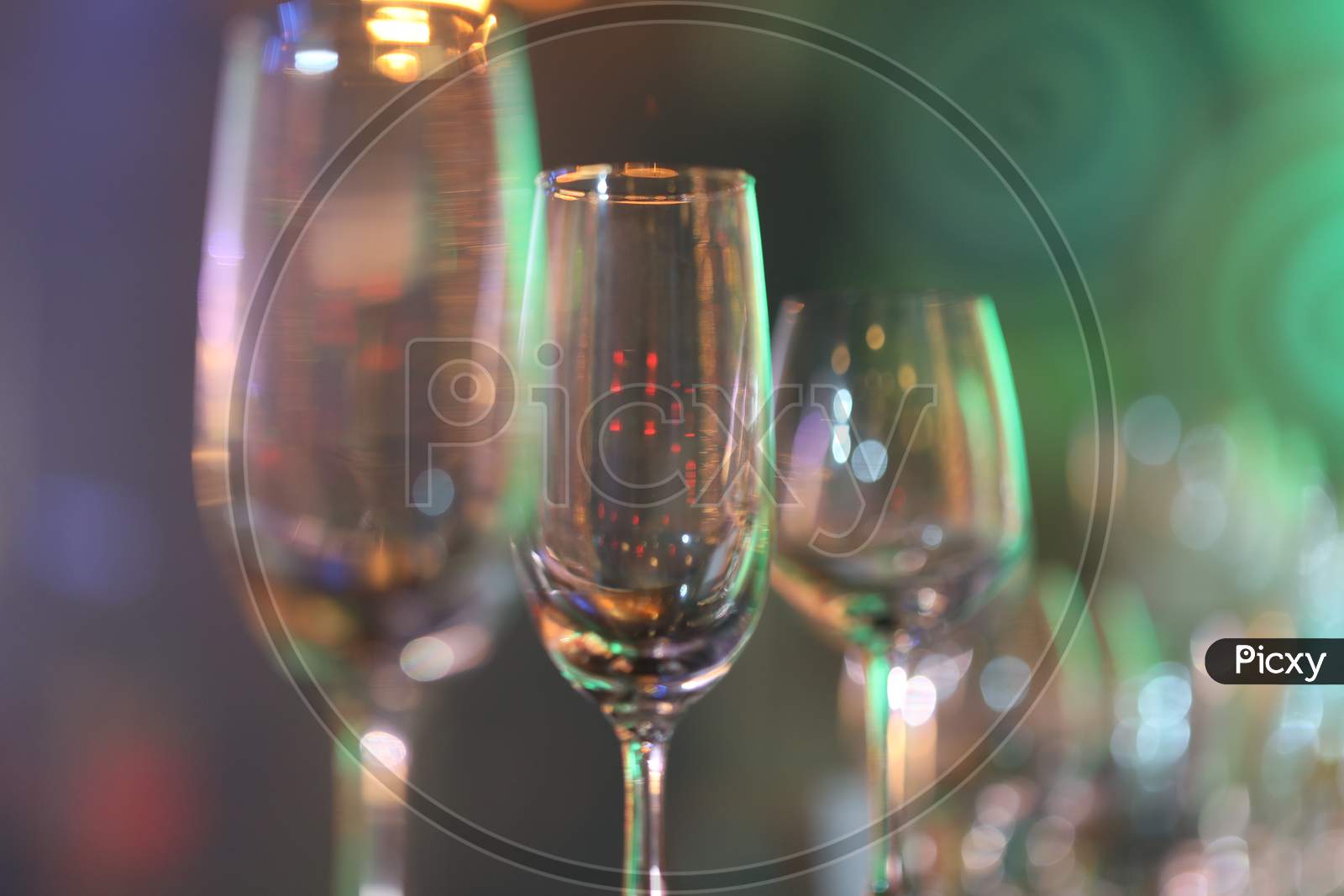 Wine Glasses At a Bar Counter With Neon Lights Flare