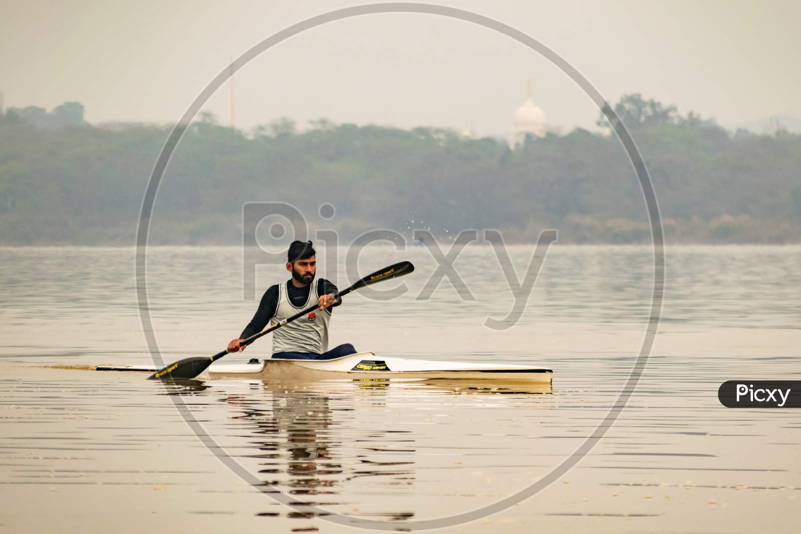 A man from punjab police rowing in the sukhna lake chandigarh
