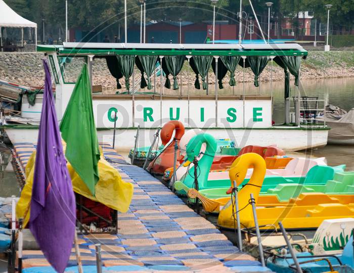 A small cruise ship and small boats at the bank of sukhna lake