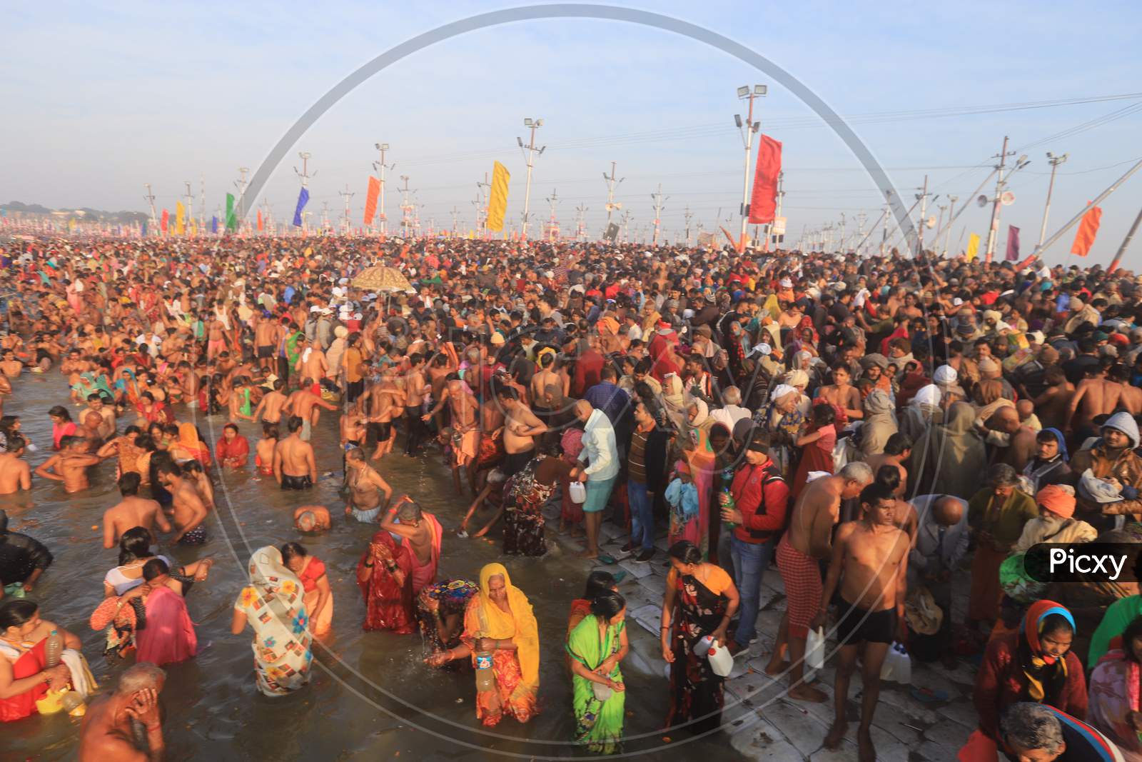 Image Of Crowd Of Hindu Devotees Taking Holy Bath In Triveni Sangam River At Prayagraj During