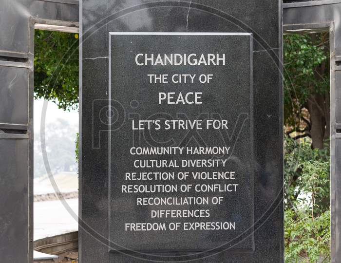 A text chandigarh the city of peace written on a structure near sukhna lake
