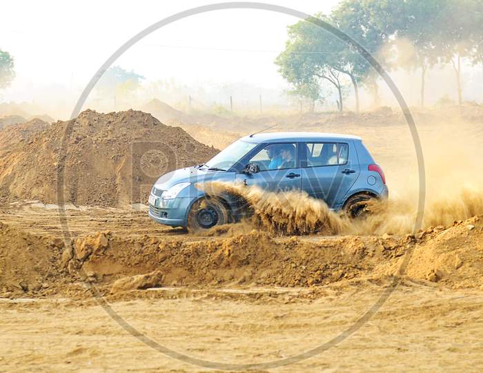 Suzuki Swift car drifting in the mud road