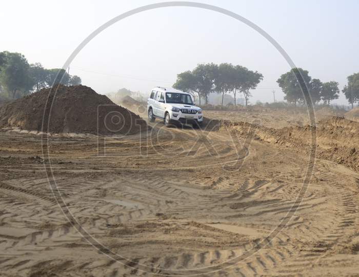 Mahindra Scorpio Car Or  Off-Road Vehicle  in an Rally Championship  With Drifting And Sand and Soil  Splashes on Rally Tracks