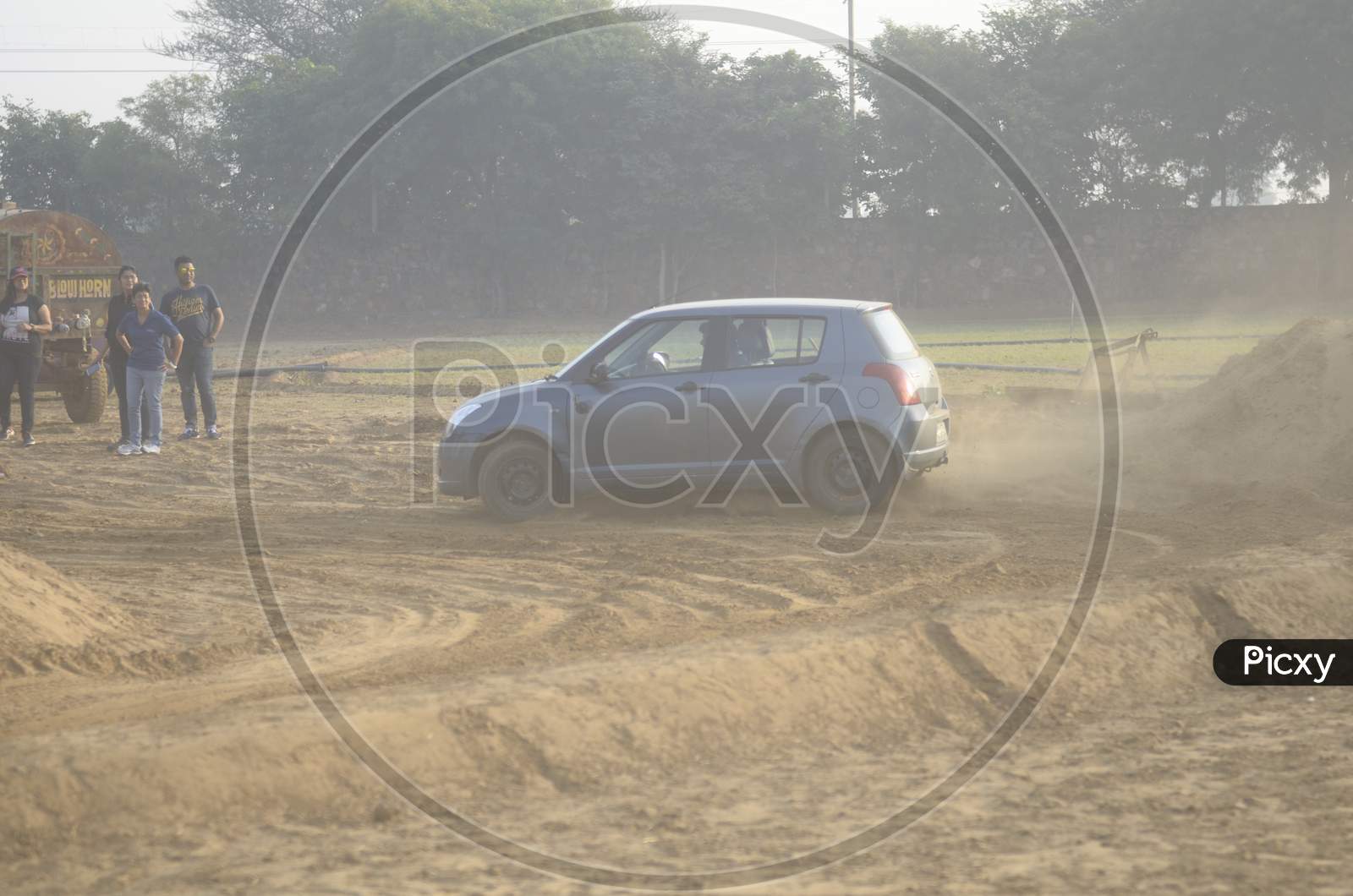 View of Maruti Suzuki Swift taking a turn in the mud road