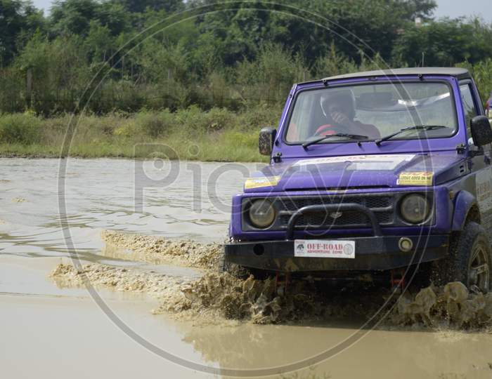 A jeep moving in the muddy water