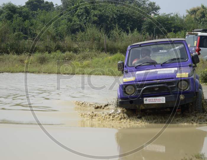 Adventure sports riding of a Jeep in the muddy water