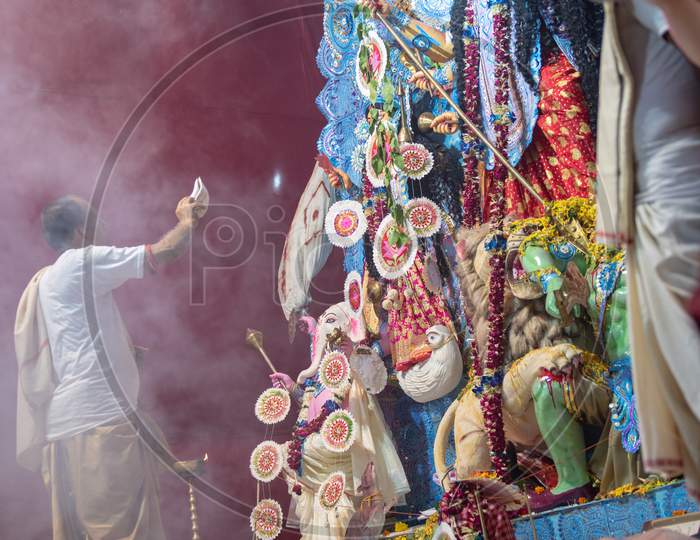 Priest Performing Haarthi Or Arthi To Goddess Durga Idols In Mandapas During Dussera