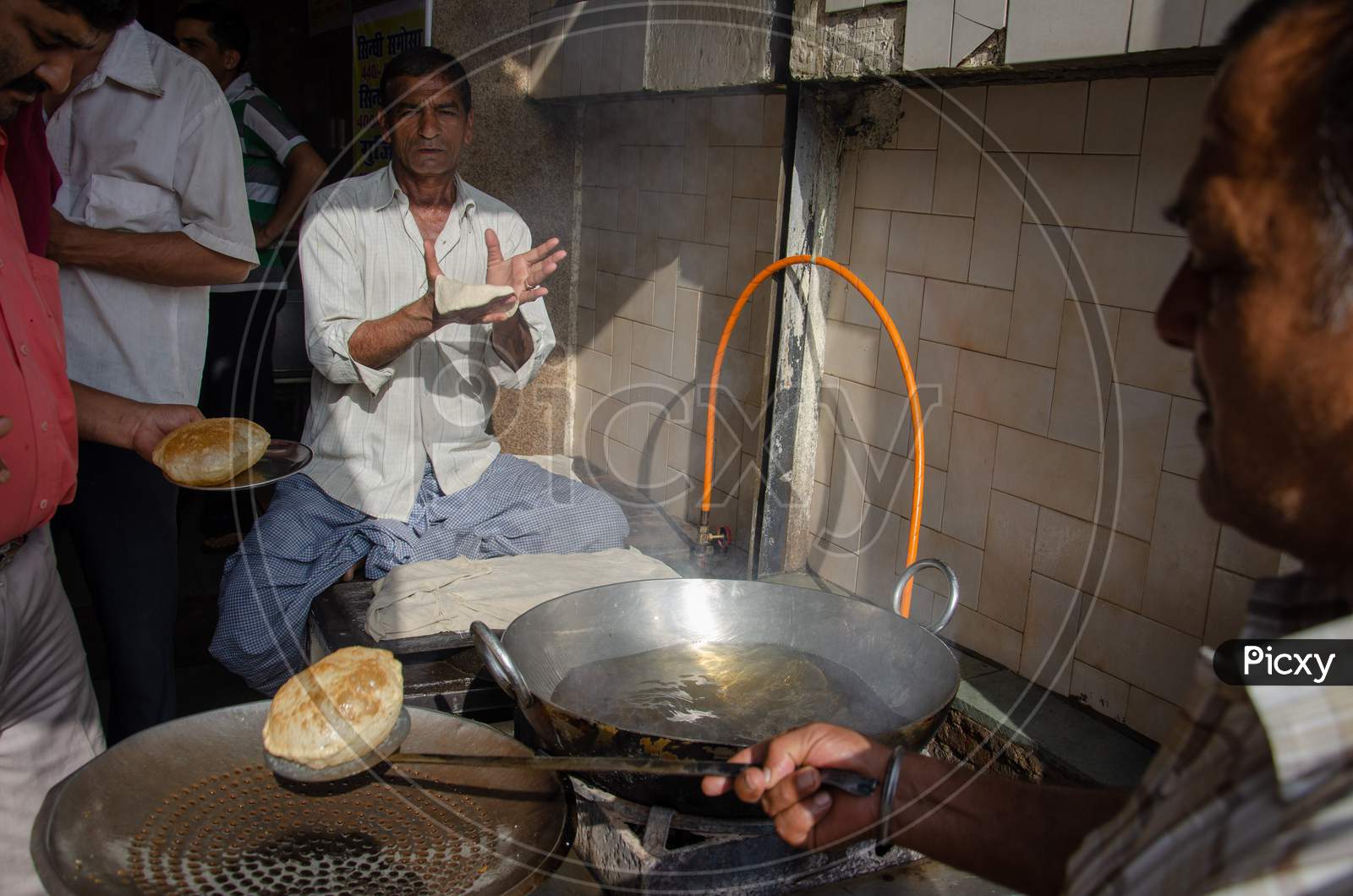 Street Food Vendor Making Poori Or Bature At a Street Food Stall