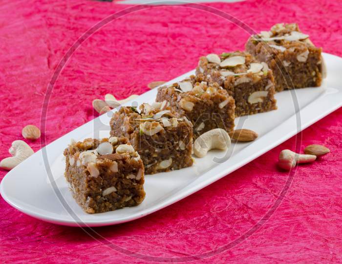 Indian Traditional Sweet   Kova Or Condensed Milk Cake   With Dry Nuts Topping Served in an Plate