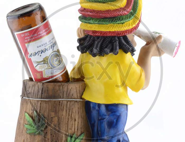 Action Figure or A Toy With Budwiser Pint in Things Holder Over an Isolated White Background
