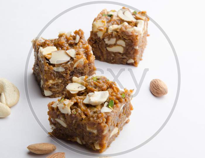 Indian Traditional Sweet  or Savory Barfi Or   Kova  With Dry Nuts Toppings  over an Isolated White Background