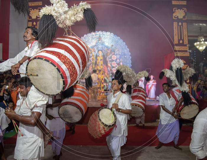 Indian dholak players performing inside a temple