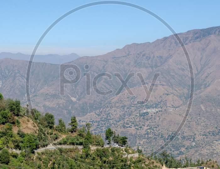 Landscape of Summit Rock Mountain With Deodar Trees in Foreground At  Mussoorie