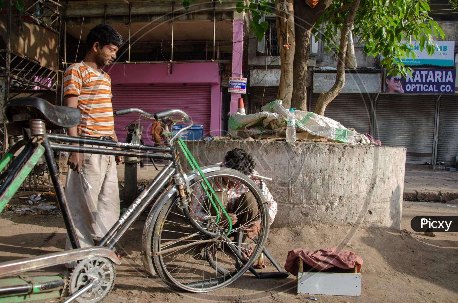Rickshaw Puller Repairing Her Tricycle Tyre