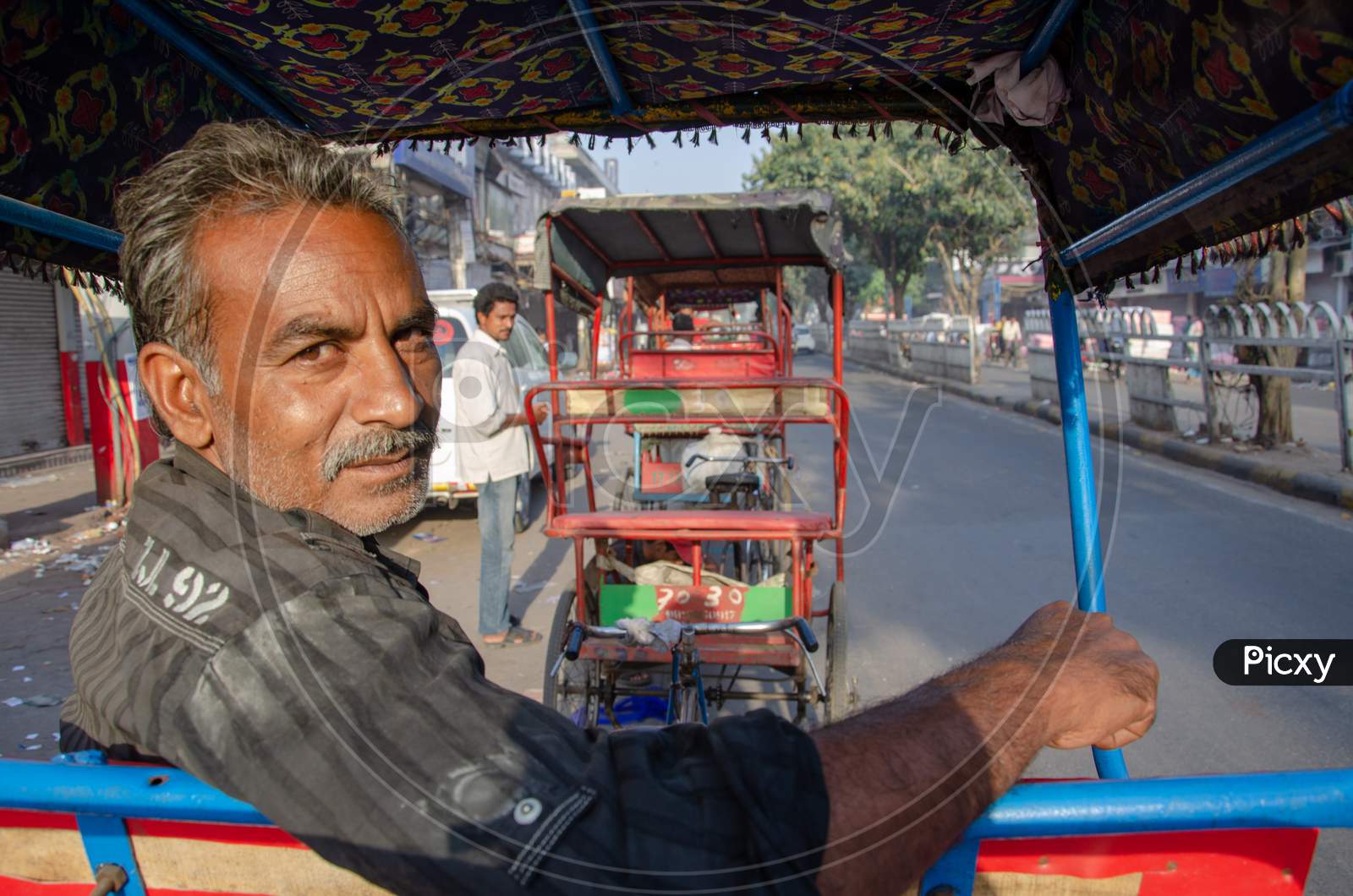 Indian man sitting in a rickshaw