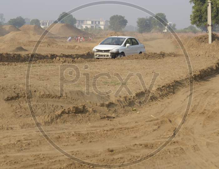A Damaged Car moving along the rally race
