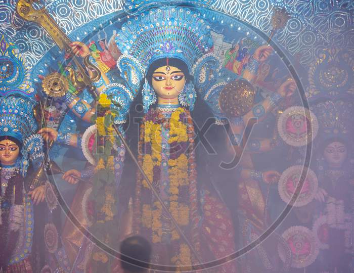 Goddess Durga Devi Statue covered in smoke during puja