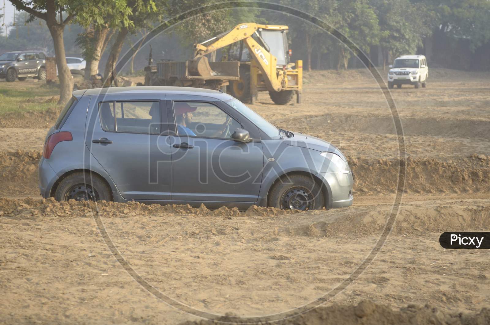 View of Maruti Suzuki Swift moving along the dirt road