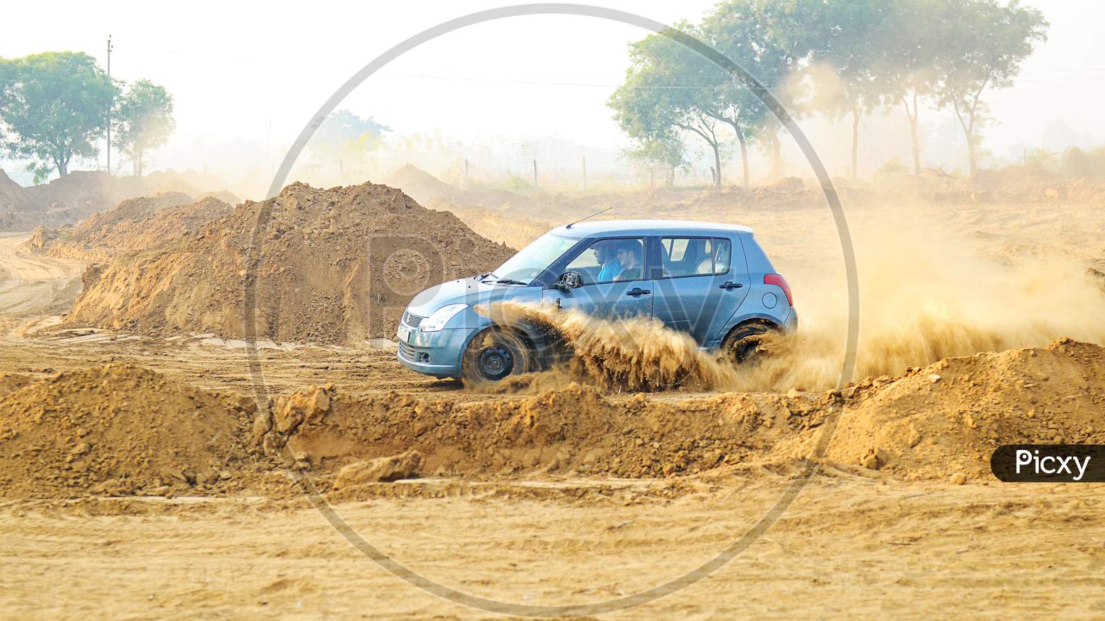 Suzuki Swift car drifting in the mud road