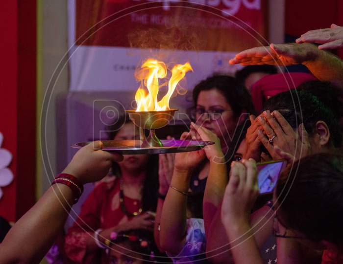 Indian Hindu Devotees praying at the sacred flame