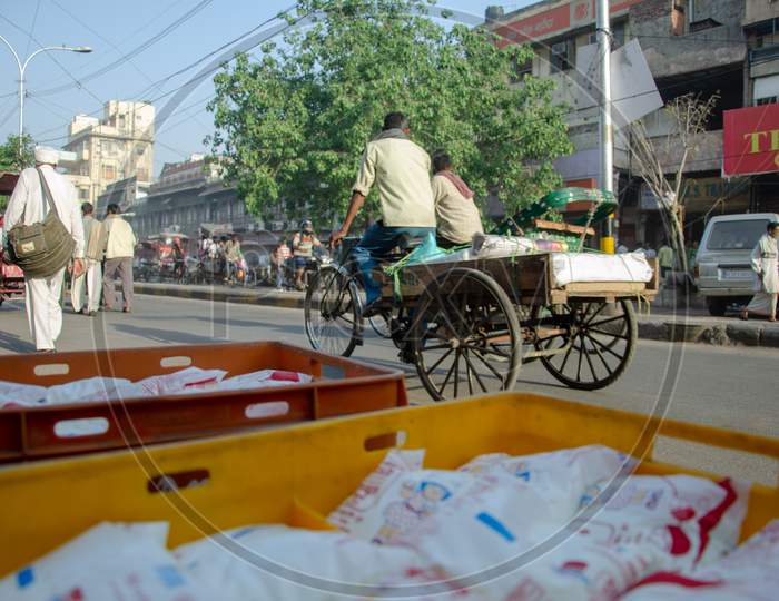 Indian man riding rickshaw
