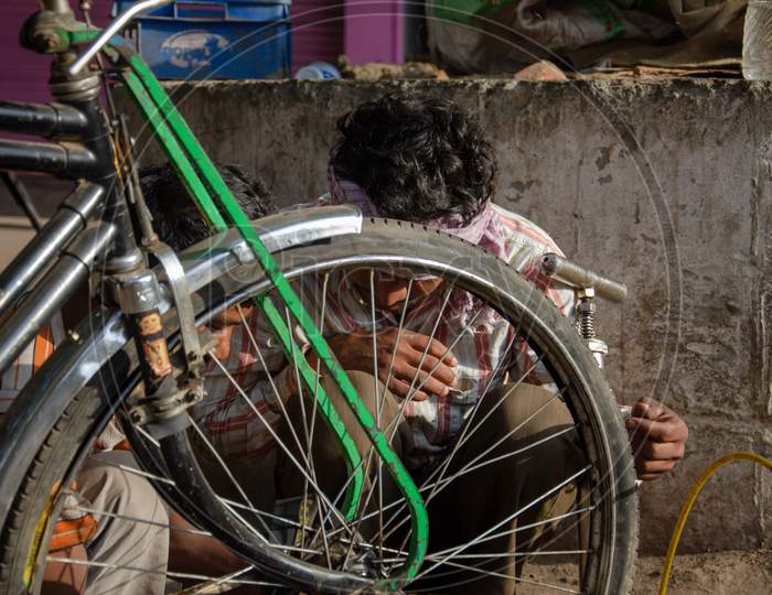 Rickshaw Puller Repairing Her Tricycle Tyre