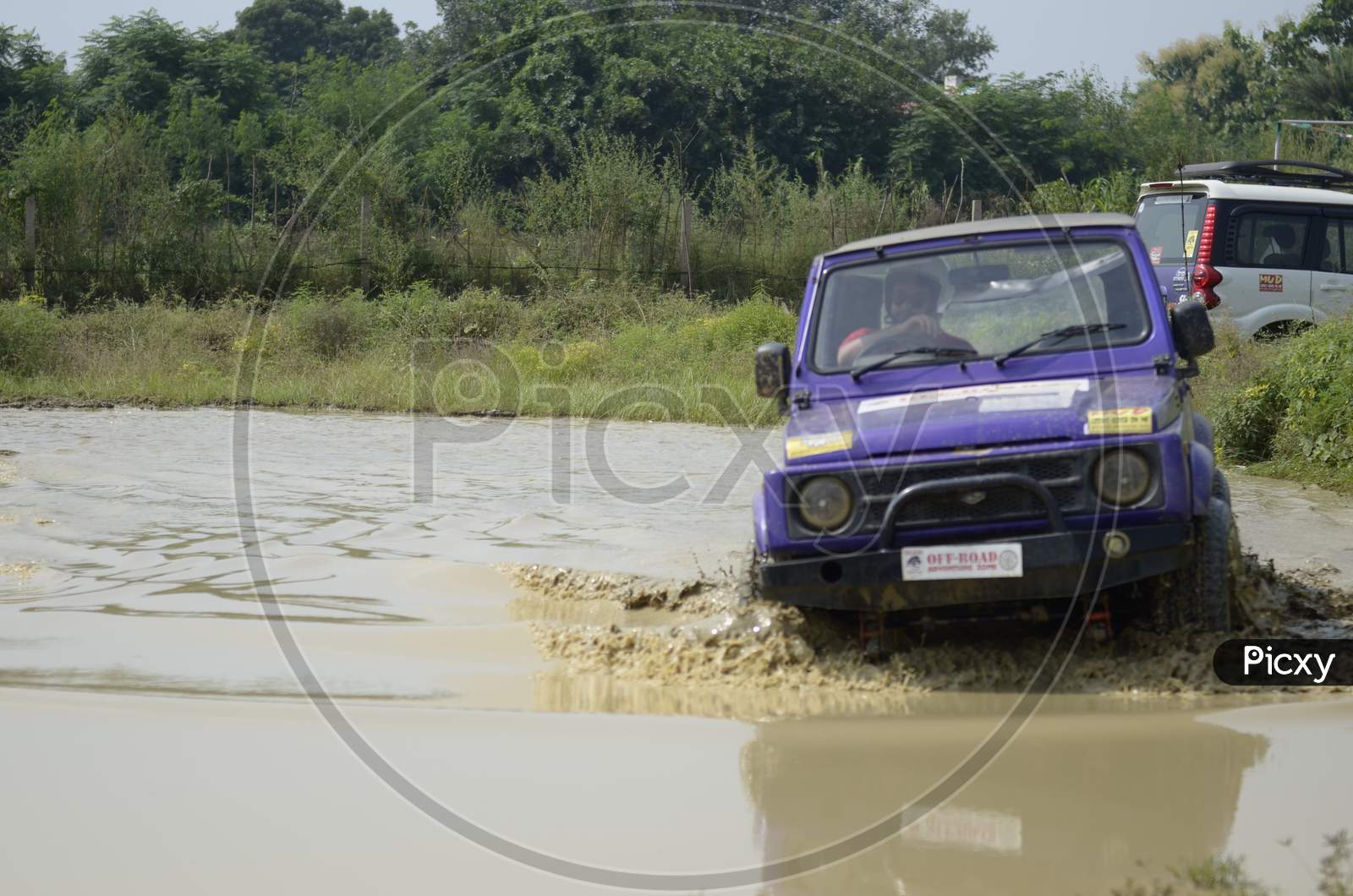 Adventure sports riding of a Jeep in the muddy water