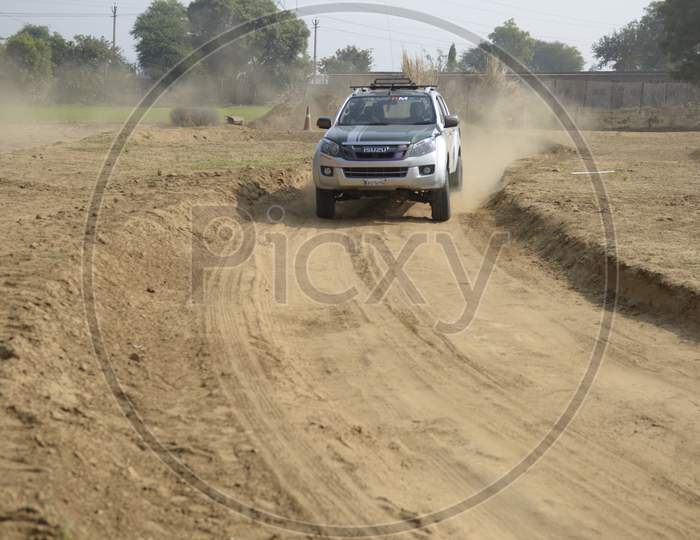 ISUZU  Off-Road Vehicle  in an Rally Championship  With Drifting And Sand and Soil  Splashes on Rally Tracks