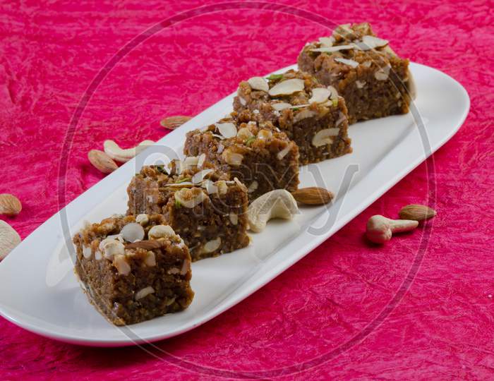 Indian Traditional Sweet   Kova Or Condensed Milk Cake   With Dry Nuts Topping Served in an Plate