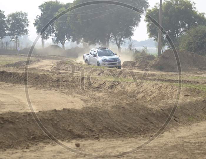 ISUZU  Off-Road Vehicle  in an Rally Championship  With Drifting And Sand and Soil  Splashes on Rally Tracks