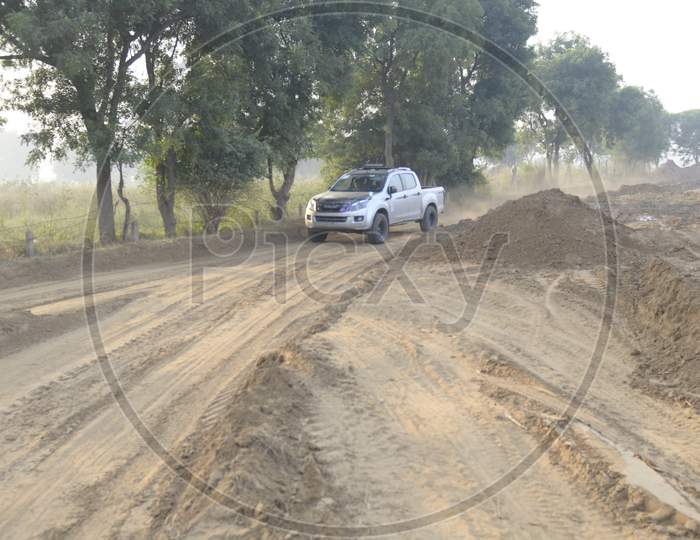 View of Isuzu Car moving on the muddy road