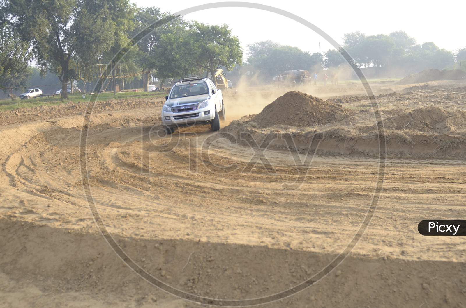 ISUZU Car Or  Off-Road Vehicle  in an Rally Championship  With Drifting And Sand and Soil  Splashes on Rally Tracks
