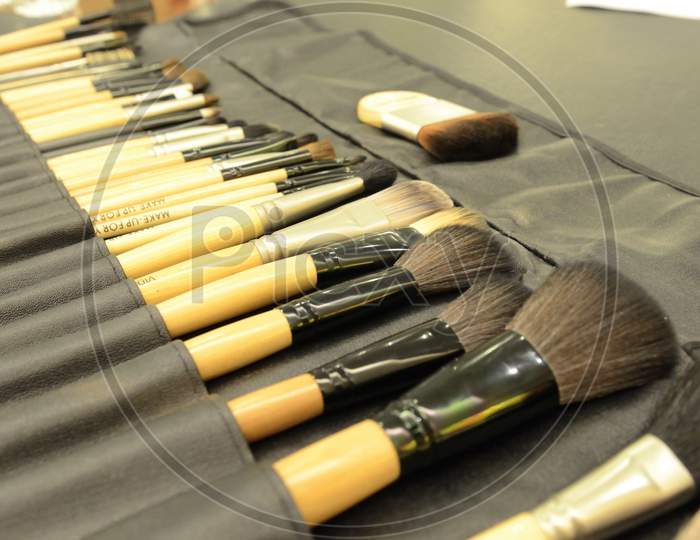 Professional Makeup Kit With  Brushes Closeup On a Table