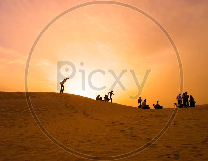 Tourists in the desert during sunset