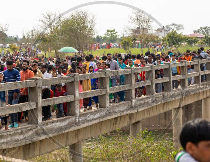 Devotees walking on a bridge to reach Saketri Shiv Mandir on the day of Maha Shivratri, Panchkula haryana