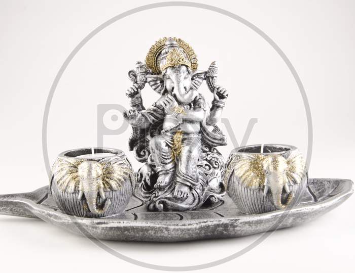 Lord Ganesh Idol Or Figurine  Over An Isolated White Background