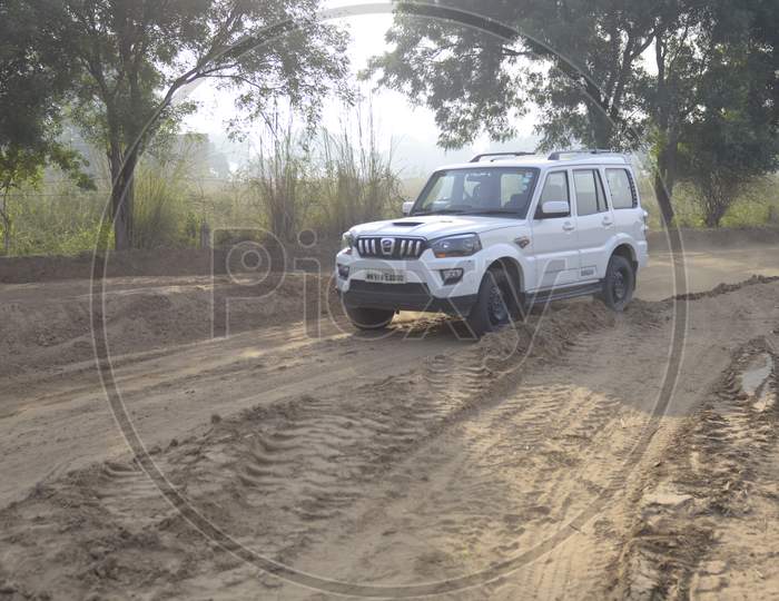 Mahindra Scorpio Car Or  Off-Road Vehicle  in an Rally Championship  With Drifting And Sand and Soil  Splashes on Rally Tracks