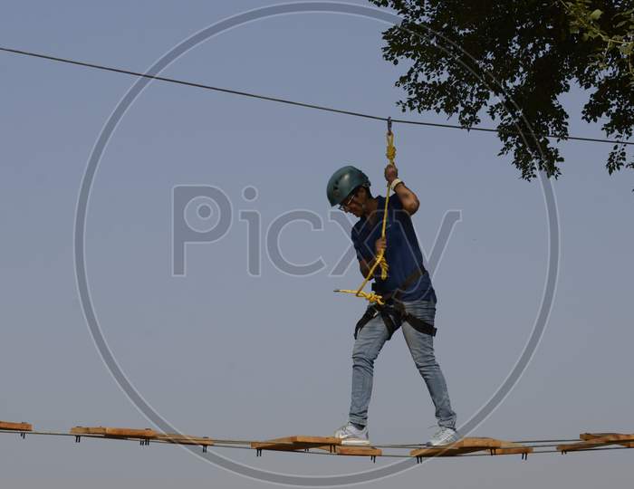 An Adventurer Practicing Rope Climbing