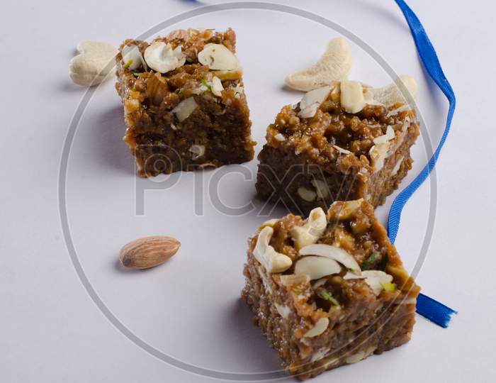 Indian Traditional Sweet  or Savory Barfi Or  Kova  With Dry Nuts Toppings  over an Isolated White Background