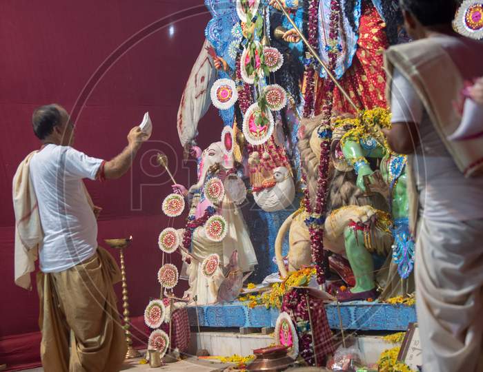 Priest Performing Haarthi Or Arthi To Goddess Durga Idols In Mandapas During Dussera