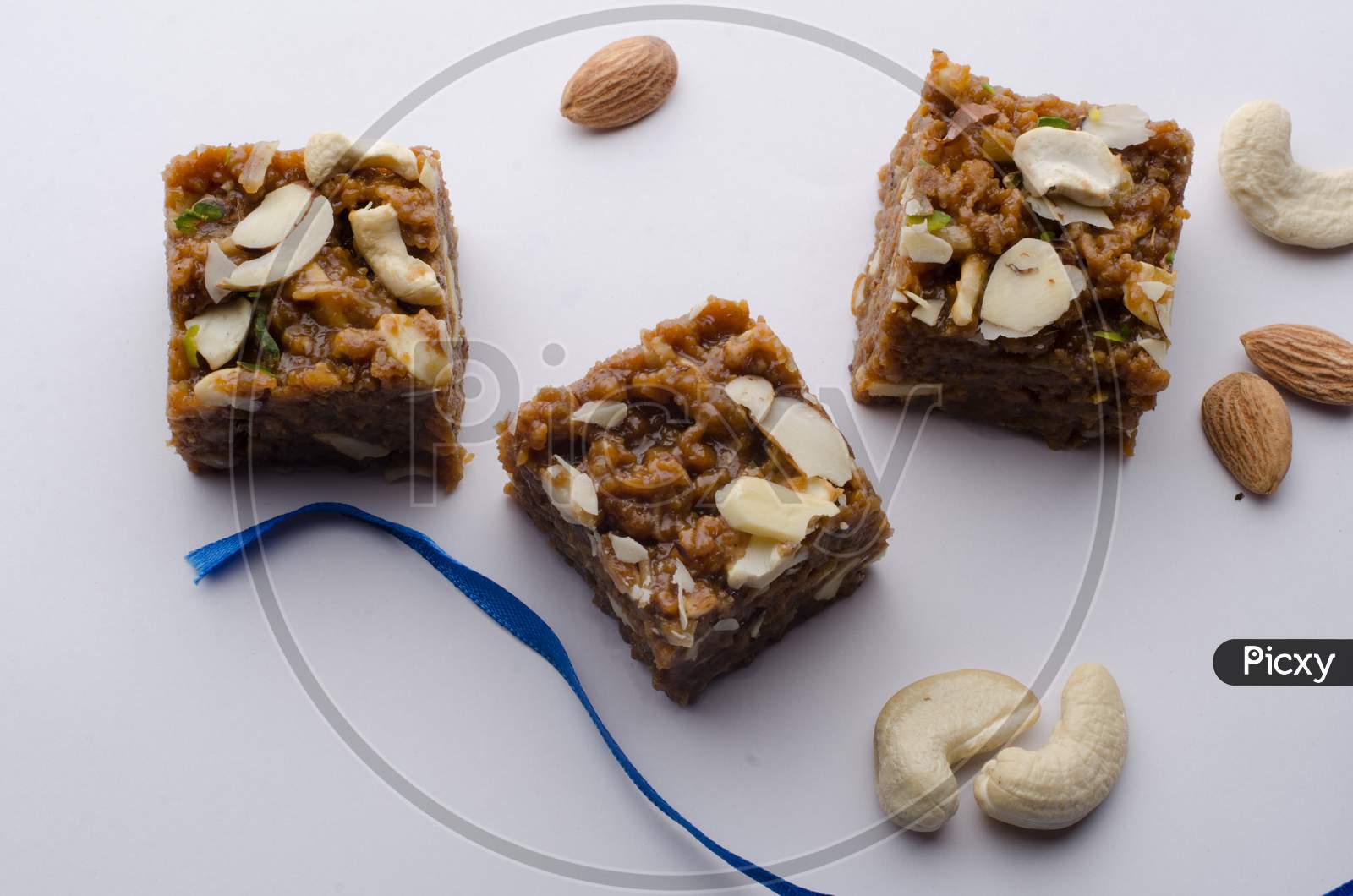 Indian Traditional Sweet  or Savory Barfi Or  Kova  With Dry Nuts Toppings  over an Isolated White Background