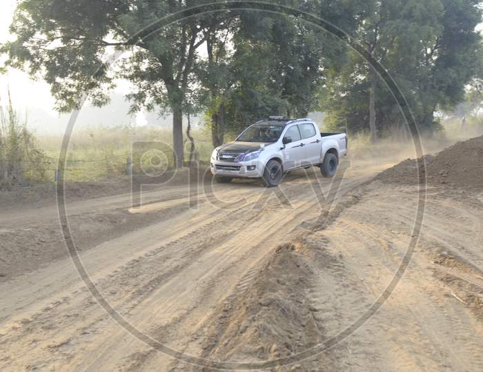 View of Isuzu Car moving along the rally race