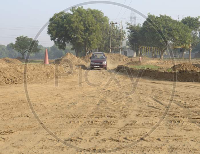View of A Maruti Suzuki Wagon R Car moving through the dirt