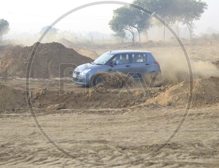 Maruthi Suzuki Swift  Car Or  Off-Road Vehicle  in an Rally Championship  With Drifting And Sand and Soil  Splashes on Rally Tracks